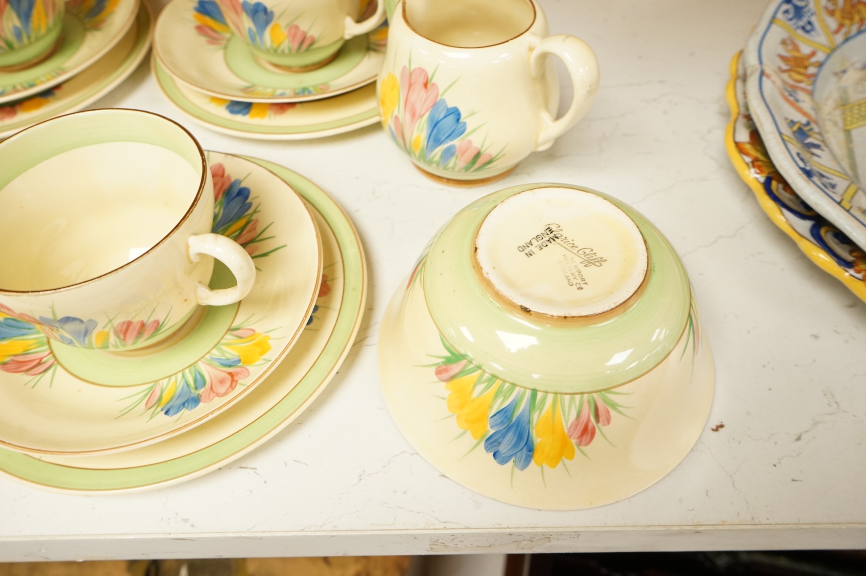 Collection of Clarice Cliff crocus pattern tea wares to include trios, milk jug, and a bowl, largest 22cm in diameter